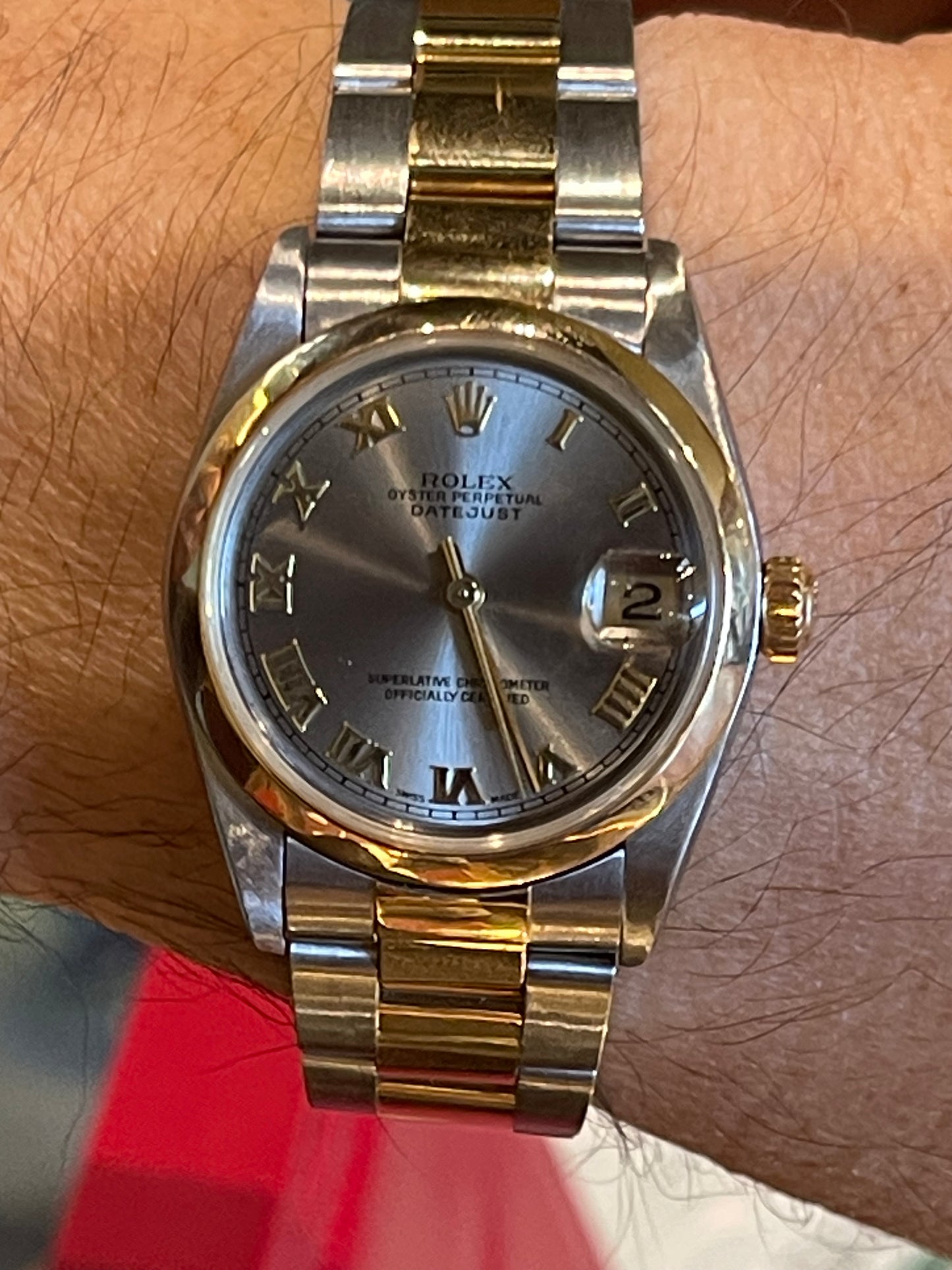 Rolex Oyster Perpetual Datejust in a two-tone or Rolesor configuration, combining stainless steel and yellow gold.