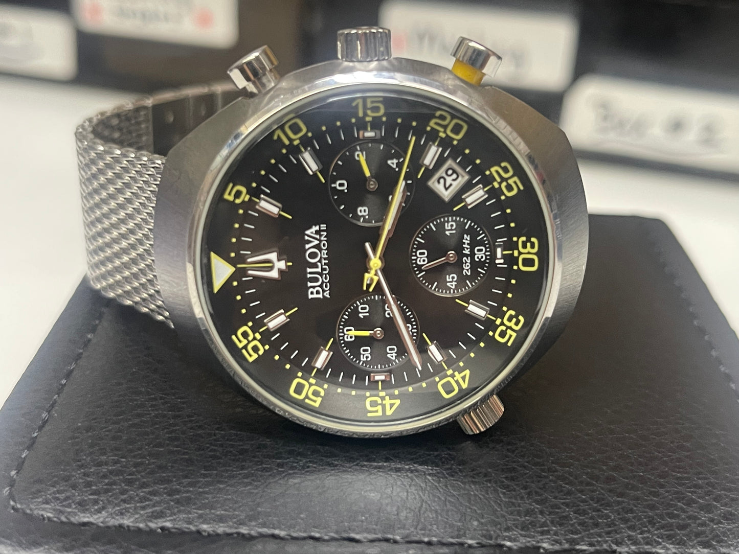 This is a Bulova Accutron II Lobster Chronograph watch with a black dial and a stainless steel mesh bracelet