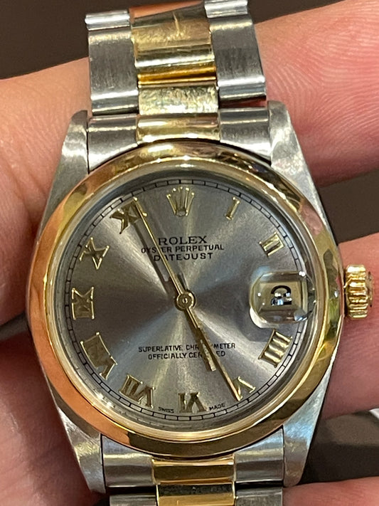 Rolex Oyster Perpetual Datejust in a two-tone or Rolesor configuration, combining stainless steel and yellow gold.