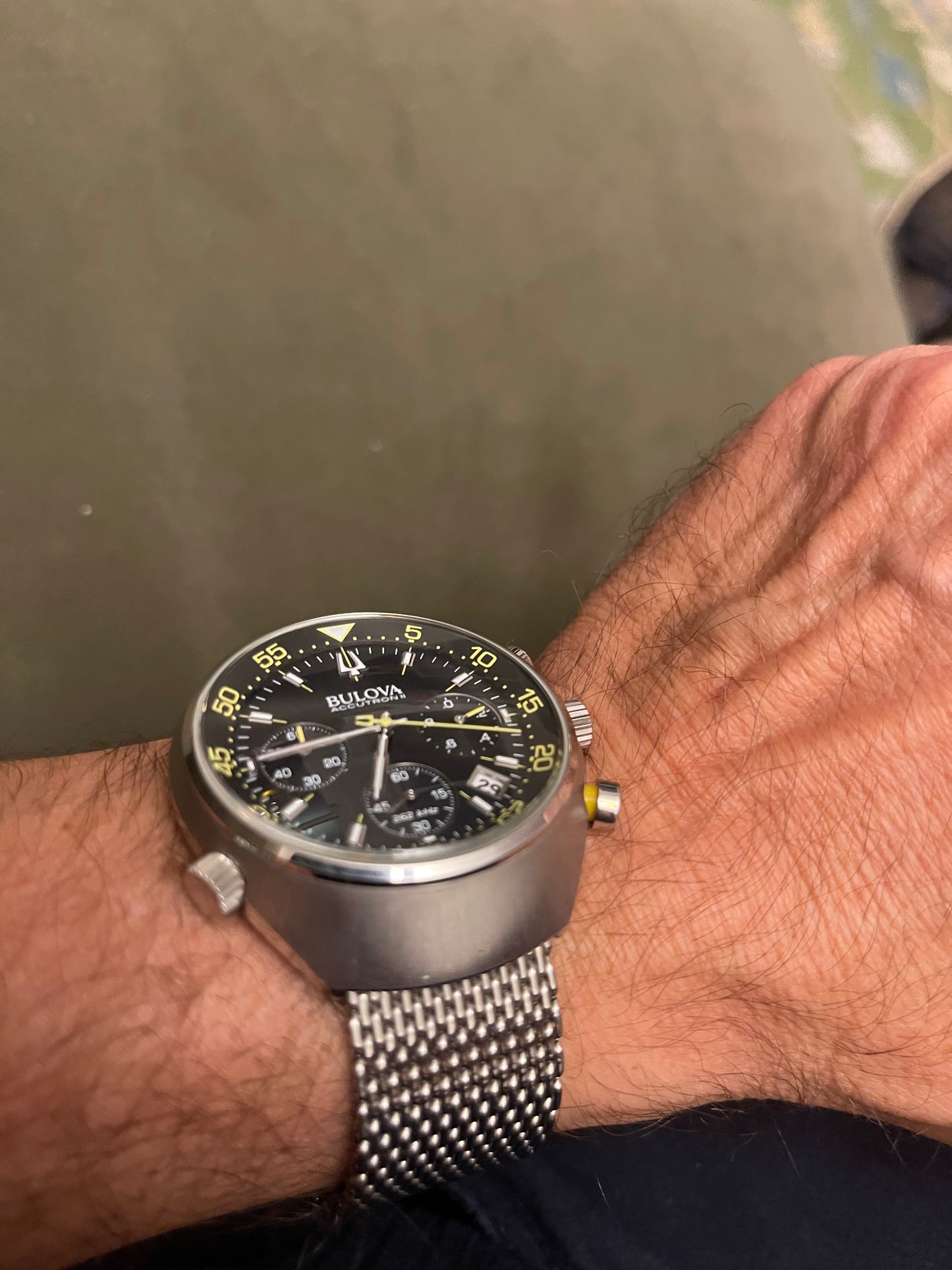 This is a Bulova Accutron II Lobster Chronograph watch with a black dial and a stainless steel mesh bracelet